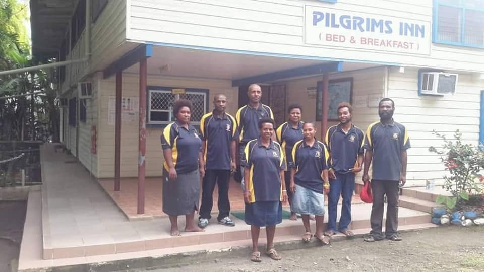 Pilgrim Village team outside the property